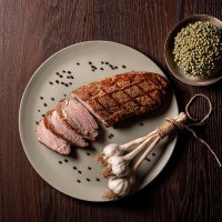 Dish with spicy pork tenderloin with decorative white onions on the side