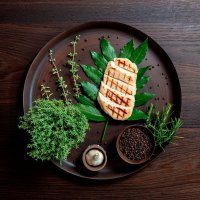 Grilled chicken breast on bed of bay leaf decoration of thyme, black pepper and rosemary