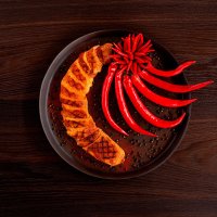 Devil's Chicken breast scalloped and grilled with red peppers decoration