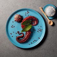Octopus tentacles with decoration salt bowl and wooden spoon