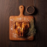 Grilled galletto with rosemary decoration