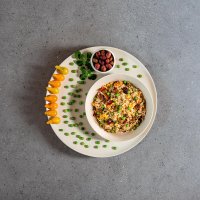 Rice salad with tomatoes, peas and olives decoration