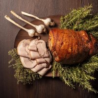 Porchetta with onions, thyme and rosemary decorations